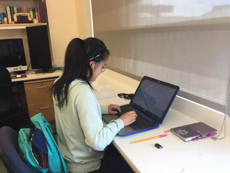 student working on a laptop computer at a lab space